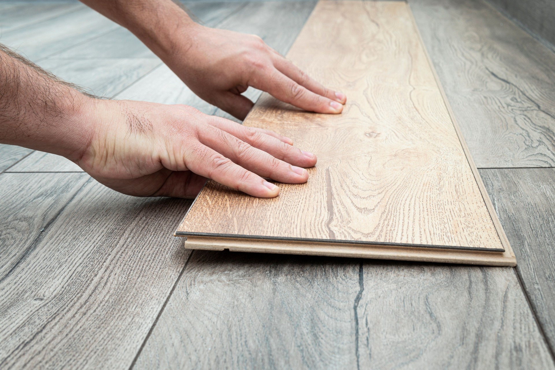 replacement of damaged laminate flooring. Renovation in the apartment. Choice of parquet. Close up of laminated flooring during replacing process